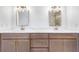 Elegant bathroom with a double vanity featuring quartz countertops, modern fixtures and warm wood cabinets at 1105 Sallete Ct, Marietta, GA 30066