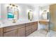 Bright bathroom featuring a double sink vanity with wood cabinets, marble countertops and modern fixtures at 1105 Sallete Ct, Marietta, GA 30066