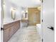 Modern bathroom with double vanity, marble floors, and a large glass shower with a soaking tub at 1105 Sallete Ct, Marietta, GA 30066