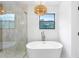 A well lit bathroom with a soaking tub and a window view at 1105 Sallete Ct, Marietta, GA 30066