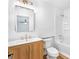 Bright bathroom featuring a wood vanity, gold fixtures, mirror, and shower/tub combo at 1105 Sallete Ct, Marietta, GA 30066