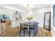 Dining area with a black table, chandelier, and view into the modern kitchen with an island at 1105 Sallete Ct, Marietta, GA 30066