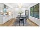 Dining room with a black table and a view to the kitchen with white cabinets and marble countertops at 1105 Sallete Ct, Marietta, GA 30066
