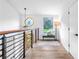 Bright hallway with modern railings, unique windows, bench seating, and wood-look floors at 1105 Sallete Ct, Marietta, GA 30066