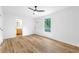 Bright living room features hard wood floors, ceiling fan, window, and entrance to a bathroom at 1105 Sallete Ct, Marietta, GA 30066