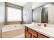 Bathroom features a soaking tub with window and a vanity with ample counter space at 2204 Dresden Nw Grn, Kennesaw, GA 30144