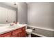 Half bath with a single sink vanity, toilet, and a large mirror at 2204 Dresden Nw Grn, Kennesaw, GA 30144