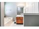 Bathroom with a bathtub, a large mirror, and a wood vanity at 2204 Dresden Nw Grn, Kennesaw, GA 30144