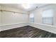 Bedroom with dark vinyl floors, light walls, and two windows with blinds at 2204 Dresden Nw Grn, Kennesaw, GA 30144