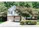 Charming two-story home featuring a two-car garage and well-maintained landscaping in a lush, green neighborhood at 2204 Dresden Nw Grn, Kennesaw, GA 30144