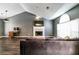 Spacious living room featuring hardwood floors, vaulted ceilings, and a cozy fireplace for relaxation at 2204 Dresden Nw Grn, Kennesaw, GA 30144