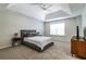 Spacious main bedroom with a tray ceiling, neutral carpet, and abundant natural light at 2204 Dresden Nw Grn, Kennesaw, GA 30144