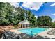 Community pool area with lounge chairs, picnic tables, and a small pavilion surrounded by mature trees at 2204 Dresden Nw Grn, Kennesaw, GA 30144