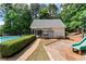 Community pool area with adjacent cabana, lush landscaping, and a playground creates a desirable community space at 2204 Dresden Nw Grn, Kennesaw, GA 30144
