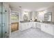 Bathroom with dual vanities, granite countertops, and a glass-enclosed shower at 4093 Groveland Park Dr, Powder Springs, GA 30127
