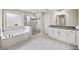 Primary bathroom features a soaking tub, glass shower, and double vanity at 4093 Groveland Park Dr, Powder Springs, GA 30127