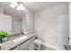 Bathroom features a granite countertop, white cabinets, and a vessel sink with a view to the shower at 4093 Groveland Park Dr, Powder Springs, GA 30127