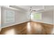 Large primary bedroom with hardwood floors, crown molding, and multiple windows at 4093 Groveland Park Dr, Powder Springs, GA 30127
