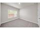 Neutral bedroom with a window and plush carpet flooring at 4093 Groveland Park Dr, Powder Springs, GA 30127