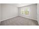 Bedroom showcasing a neutral color palette, plush carpeting, window views, and ample natural light at 4093 Groveland Park Dr, Powder Springs, GA 30127