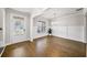 Bright dining room with hardwood floors, wainscoting, large windows, and a modern chandelier at 4093 Groveland Park Dr, Powder Springs, GA 30127