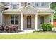 Charming covered front porch with brick columns and landscaping at 4093 Groveland Park Dr, Powder Springs, GA 30127