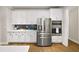 Modern kitchen featuring stainless steel appliances, white cabinets, and a stylish backsplash at 4093 Groveland Park Dr, Powder Springs, GA 30127