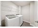 Laundry room features new side-by-side Samsung washer and dryer and wire shelving at 4093 Groveland Park Dr, Powder Springs, GA 30127