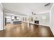 Open-concept living room with a fireplace, hardwood floors, and an adjacent kitchen at 4093 Groveland Park Dr, Powder Springs, GA 30127