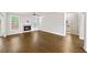 Spacious living room with wood floors, fireplace and view into a bathroom at 4093 Groveland Park Dr, Powder Springs, GA 30127