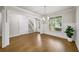 Bright living room with hardwood floors, white wainscoting, a chandelier and staircase at 4093 Groveland Park Dr, Powder Springs, GA 30127