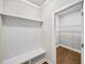 Mud room featuring a bench and storage with access to a walk-in closet at 4093 Groveland Park Dr, Powder Springs, GA 30127
