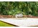 Playground climber on sand in a wooded area, perfect for Gathering fun at 4093 Groveland Park Dr, Powder Springs, GA 30127