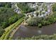 Aerial view of community featuring a pond with a water fountain, walking trails and tree-lined streets at 139 Lake Reserve Way, Canton, GA 30115