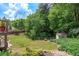 Fenced backyard featuring mature trees and a utility shed at 139 Lake Reserve Way, Canton, GA 30115