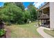 Spacious backyard with lush greenery, privacy fence, and access to a covered patio at 139 Lake Reserve Way, Canton, GA 30115