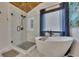 Stunning bathroom featuring a modern soaking tub, glass-enclosed shower, and elegant finishes at 139 Lake Reserve Way, Canton, GA 30115
