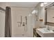 Well-lit bathroom featuring glass shower, neutral tile, and vanity with mirror at 139 Lake Reserve Way, Canton, GA 30115