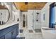 Modern bathroom with soaking tub, walk-in shower, marble floors and wood plank ceiling at 139 Lake Reserve Way, Canton, GA 30115