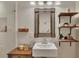 Bright bathroom featuring decorative mirror and shelves above vanity at 139 Lake Reserve Way, Canton, GA 30115