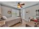 Cozy bedroom with a ceiling fan, wood laminate flooring, and ample natural light at 139 Lake Reserve Way, Canton, GA 30115