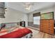 Comfortable bedroom featuring ceiling fan, dresser, and wood laminate flooring at 139 Lake Reserve Way, Canton, GA 30115
