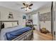 Comfortable bedroom with ceiling fan, wood laminate flooring and natural light at 139 Lake Reserve Way, Canton, GA 30115