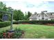 Exterior of the Harmony Lake Club featuring a well-manicured lawn and flower beds at 139 Lake Reserve Way, Canton, GA 30115