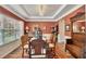 Elegant dining room featuring a tray ceiling, rustic decor, and natural light from the large window at 139 Lake Reserve Way, Canton, GA 30115