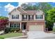 Charming two-story home with brick accents, a well-manicured lawn, and a two-car garage at 139 Lake Reserve Way, Canton, GA 30115