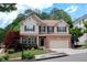 Inviting two-story home with a brick facade, tidy landscaping, and an attached two-car garage at 139 Lake Reserve Way, Canton, GA 30115