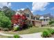 Picturesque two-story home with lush landscaping and a charming brick and siding exterior at 139 Lake Reserve Way, Canton, GA 30115