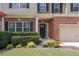 Close-up of a home's entrance showcasing a brick facade, beautiful landscaping, and an elegant front door at 139 Lake Reserve Way, Canton, GA 30115