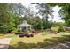 Idyllic gazebo on lush green lawn surrounded by colorful landscaped beds overlooking the pond at 139 Lake Reserve Way, Canton, GA 30115
